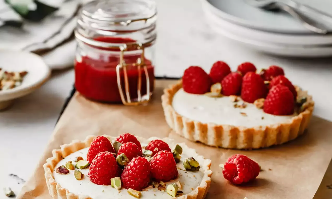 Vanilla tarts with raspberries and pistachios